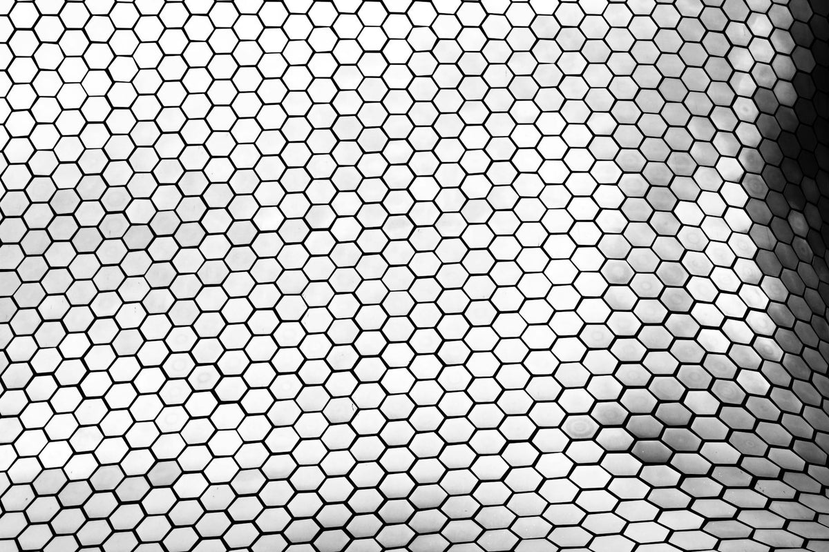 Black and white geometric pattern of Museo Soumaya's facade in Mexico City, showcasing hexagonal shapes.