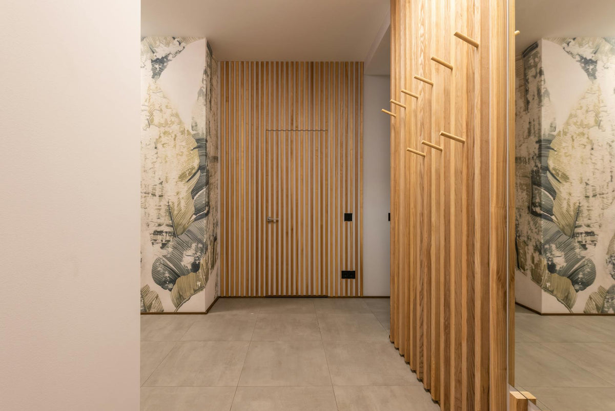 Elegant hallway interior featuring wooden panels and artistic wallpaper.