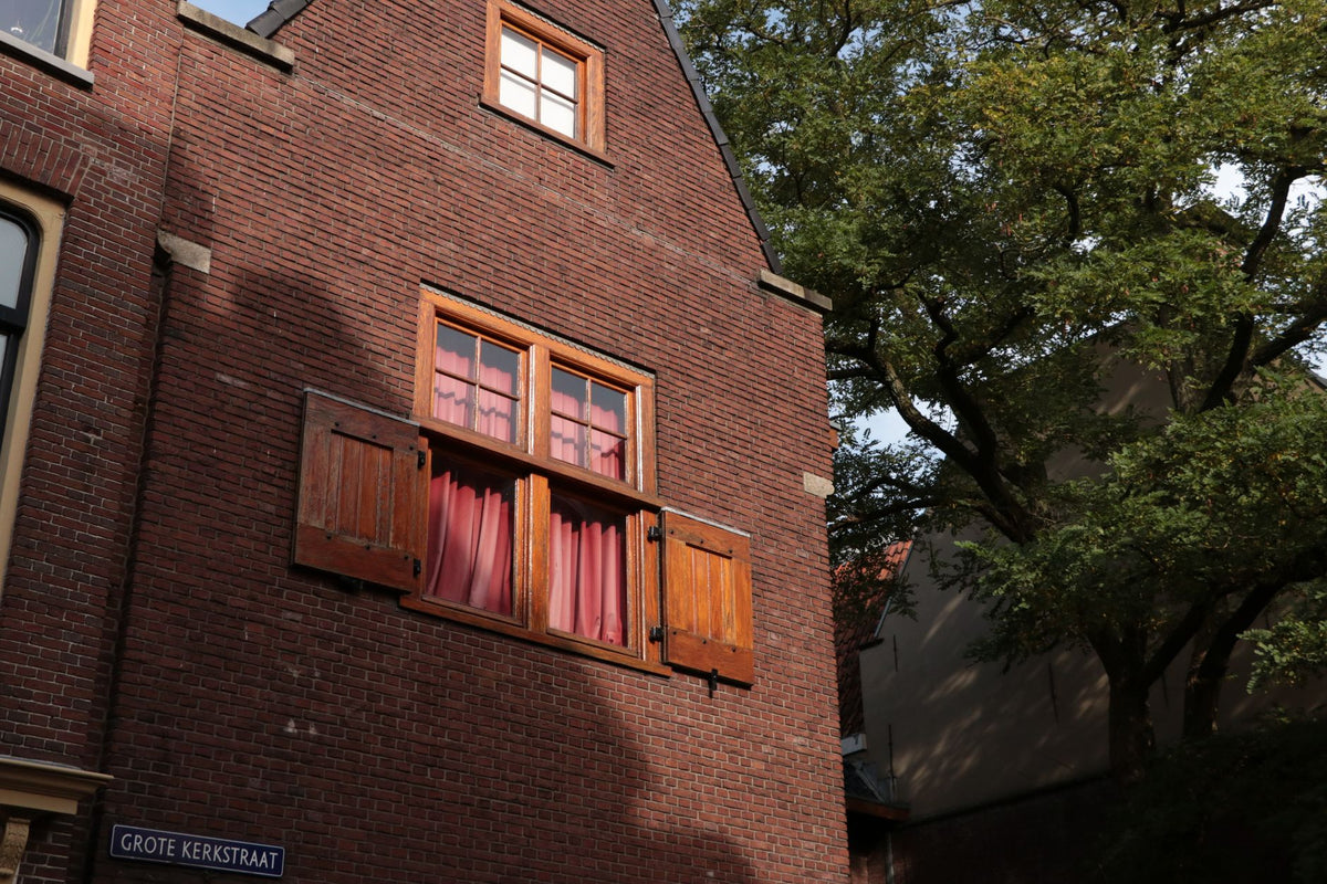 Historic brick building with wooden windows in Leeuwarden, Friesland.